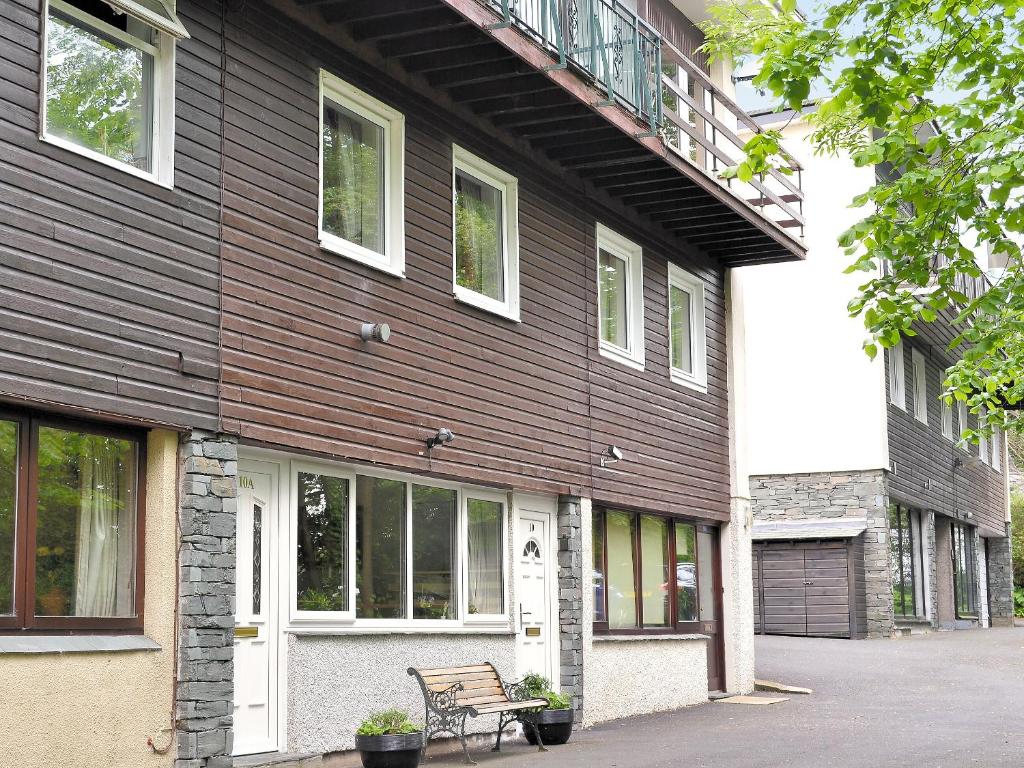 a wooden building with a bench in front of it at Belle View - 26645 in Bowness-on-Windermere