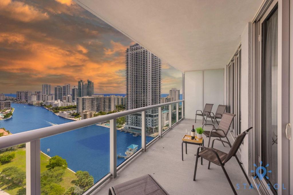 a balcony with chairs and a view of the city at Balcony with Infinite Views - Poolside Comfort in Hallandale Beach