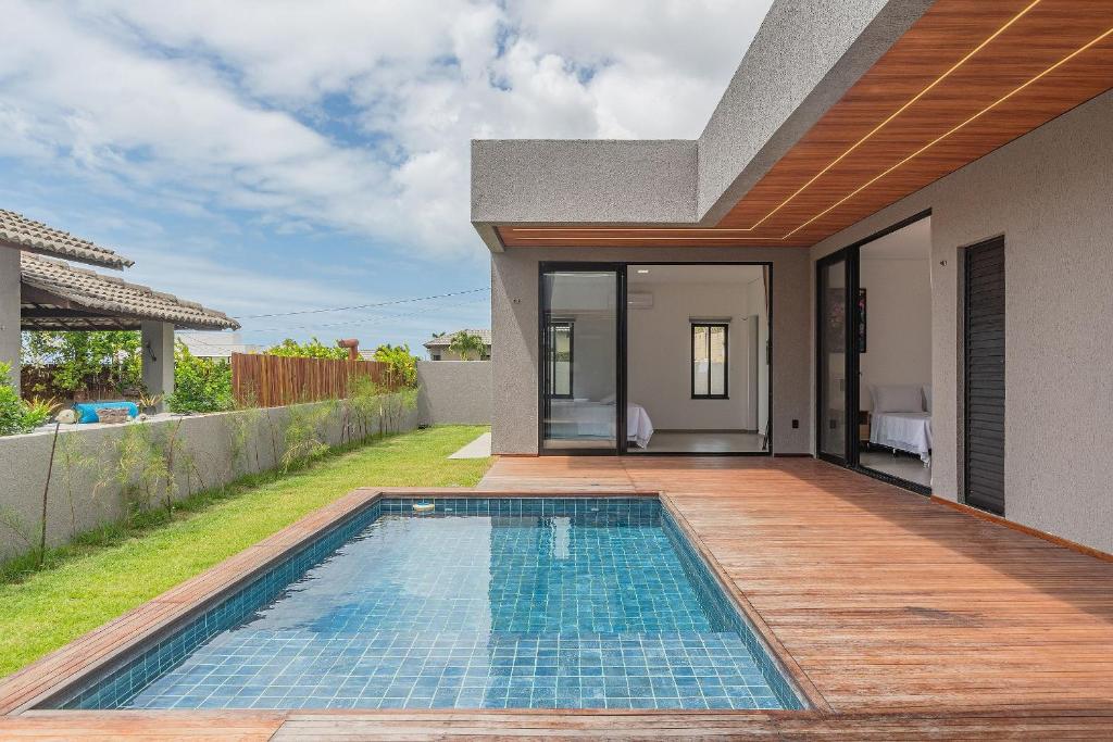 a swimming pool in the backyard of a house at Summerville #269 - Casa em Cumbuco by Carpediem in Caucaia