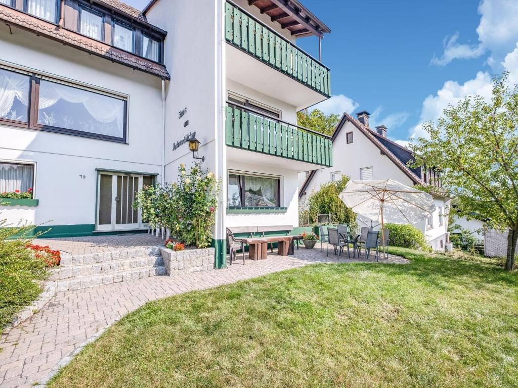 an exterior view of a house with a patio at Geräumiges Apartment am Waldrand im Sauerland in Medebach