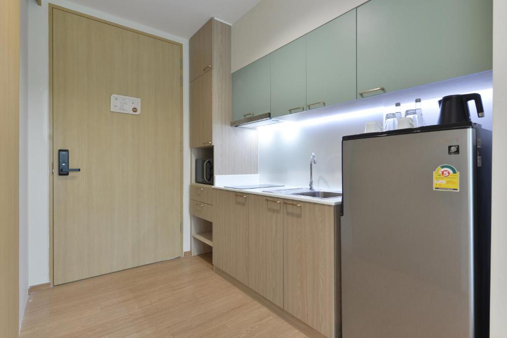 A compact in-room kitchenette with a sink, microwave and refrigerator.
