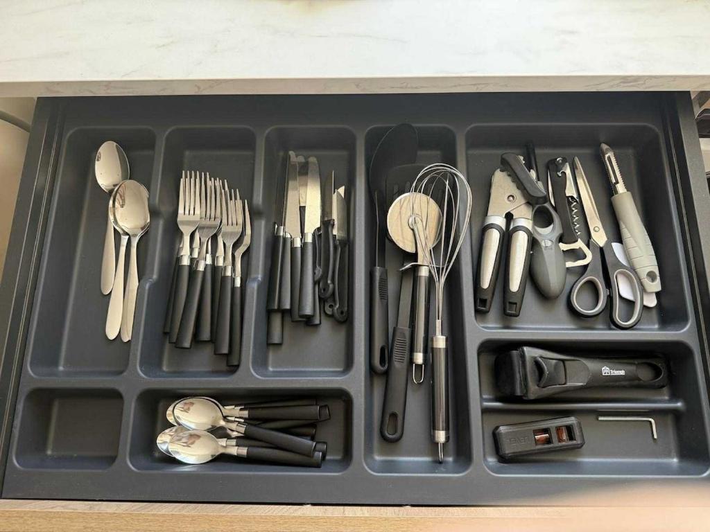a tray full of utensils sitting on a table at Ambiance Bohème, Confort Cosy in Calais