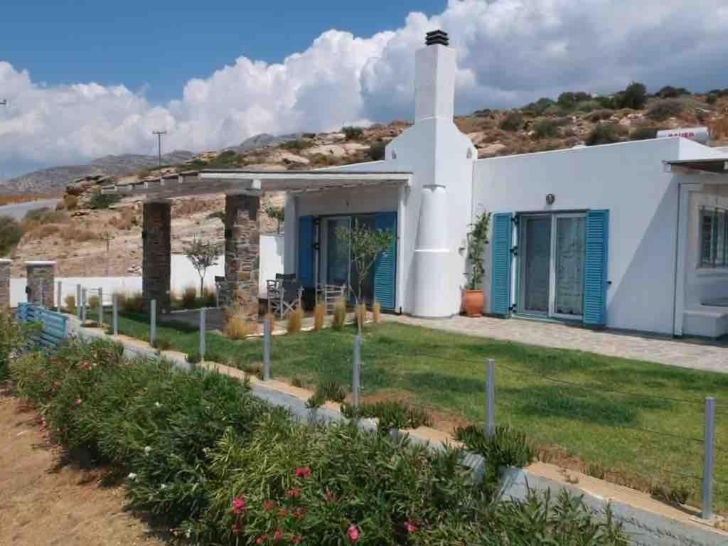 a white house with a hill in the background at Fairytale View in Karistos