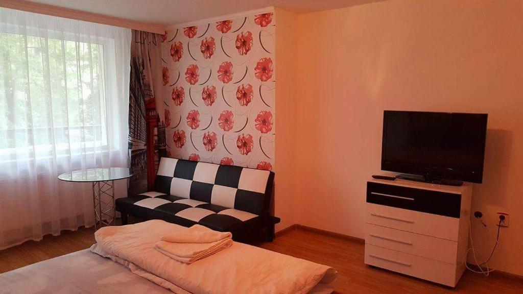 a living room with a couch and a flat screen tv at Escape Shumen in Shumen