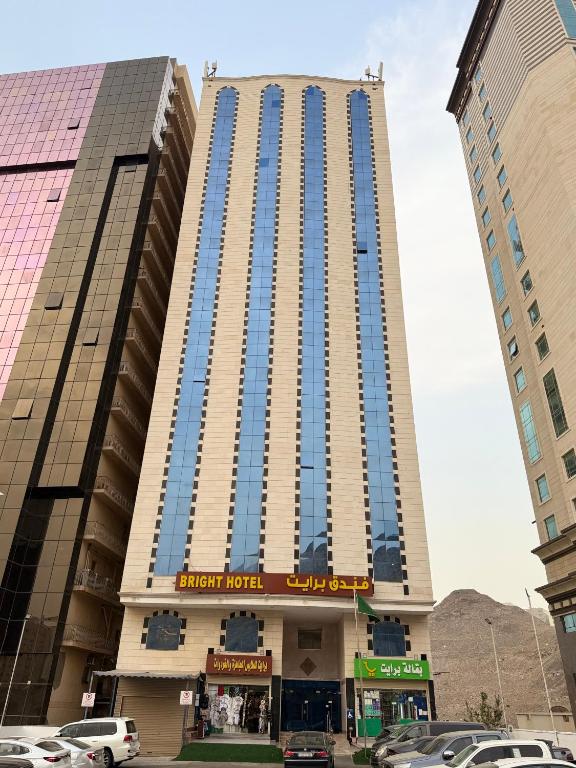 a tall building with blue windows in a city at فندق برايت in Mecca