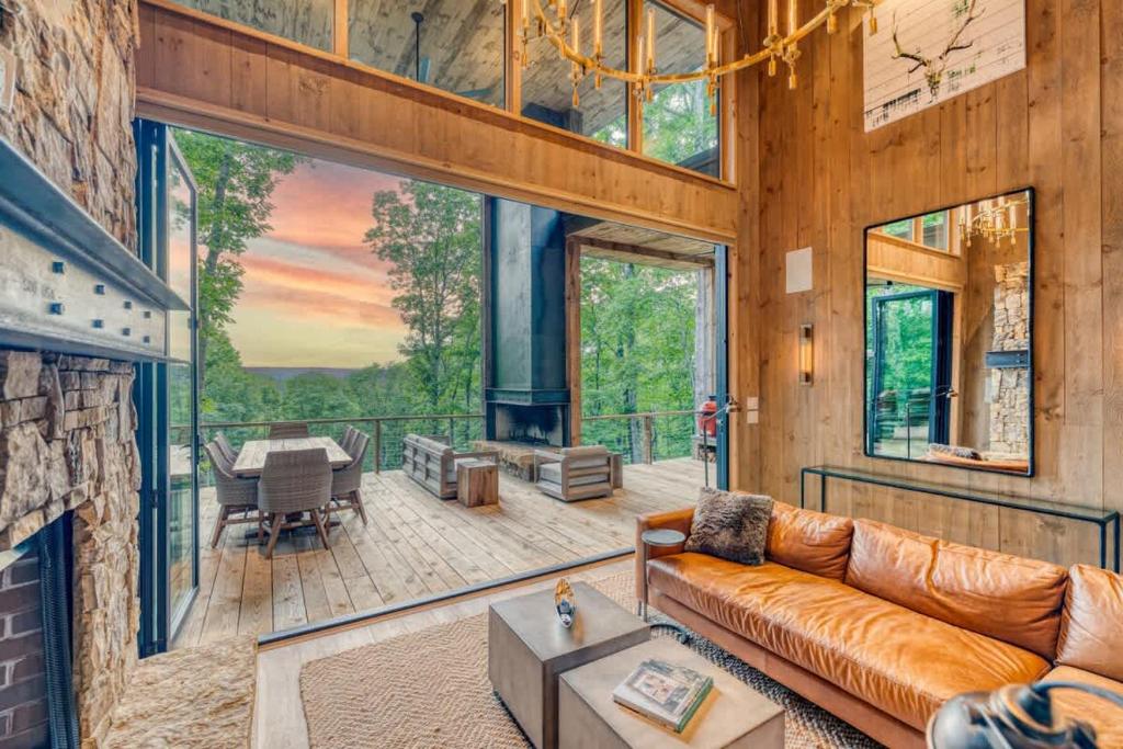 a living room with a couch and a fireplace at Greenridge- Upscale Architecture and Modern Design in Blue Ridge