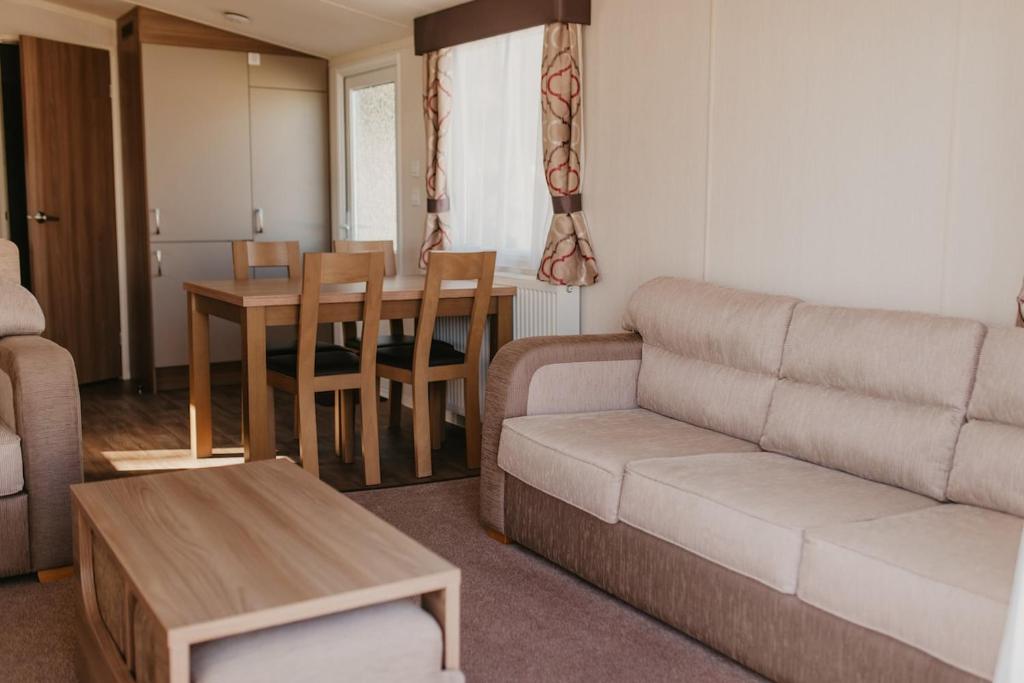 a living room with a couch and a table at Lower Cliff 9 in Portland