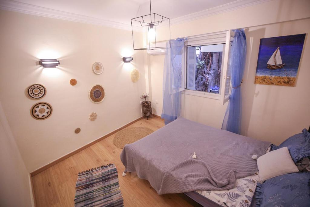 a small room with a bed and a window at Sunny Garden Apartment in central kolonaki Athens in Athens
