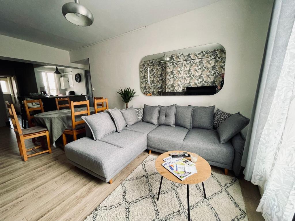 a living room with a couch and a table at Appartement 80m2 à deux pas du beffroi in Arras