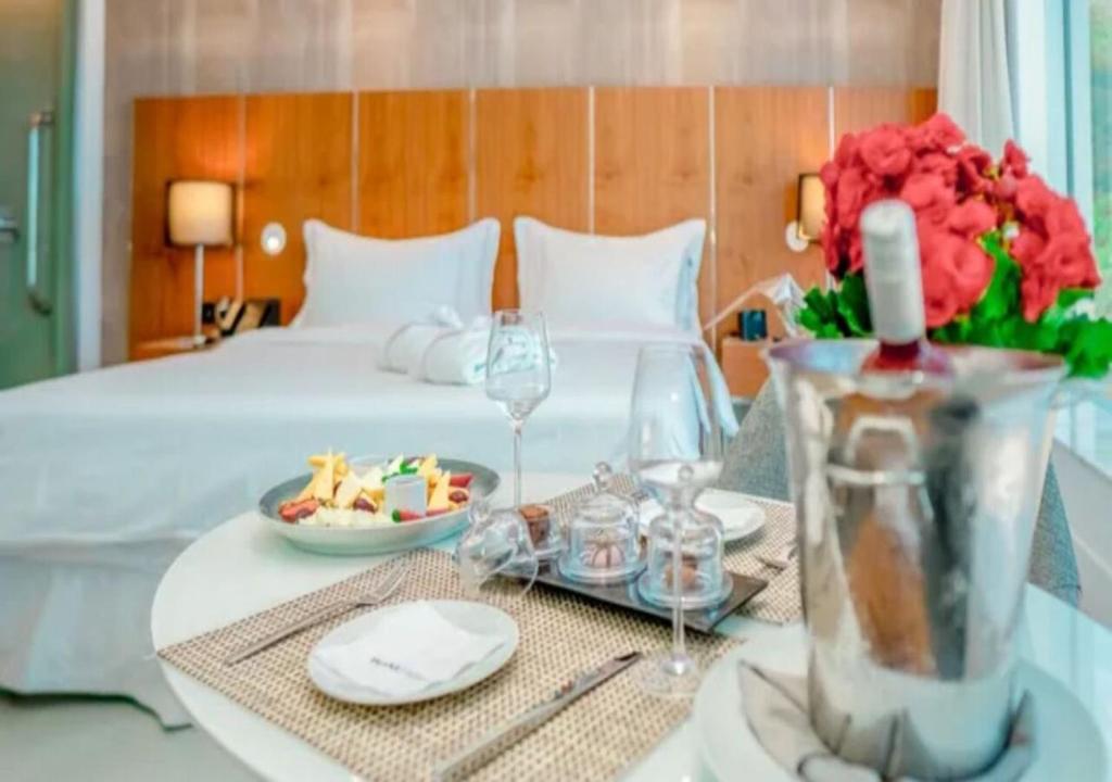 a hotel room with a bed and a table with food and drinks at Hotel Nacional Rio de Janeiro in Rio de Janeiro