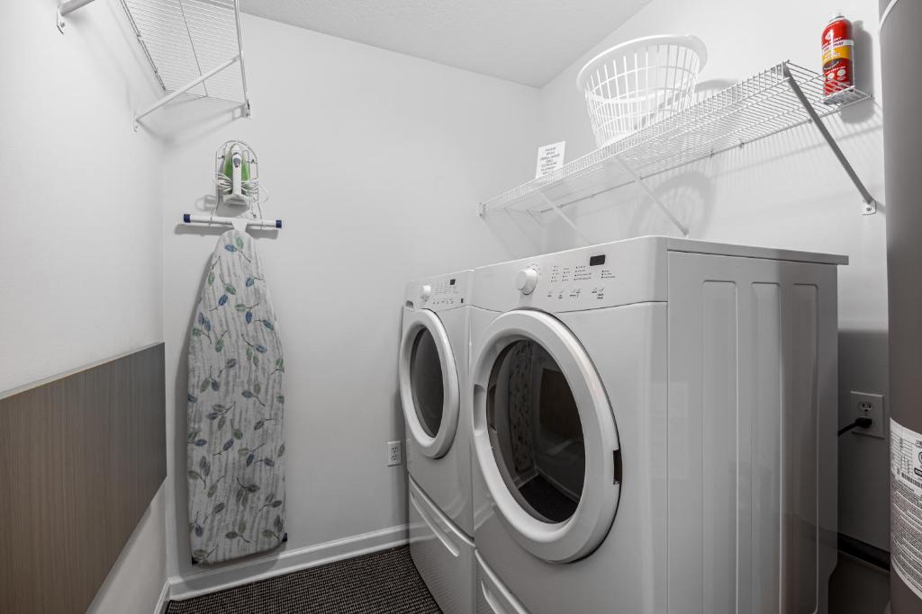 a washer and dryer in a white laundry room at Easy Livin by American Patriot Getaways in Waldens Creek