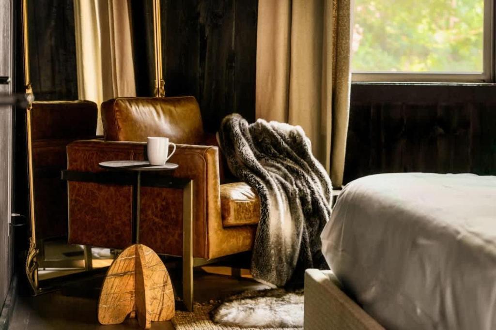 a bedroom with a bed and a chair with a blanket at Midnight Mountain in Sevierville