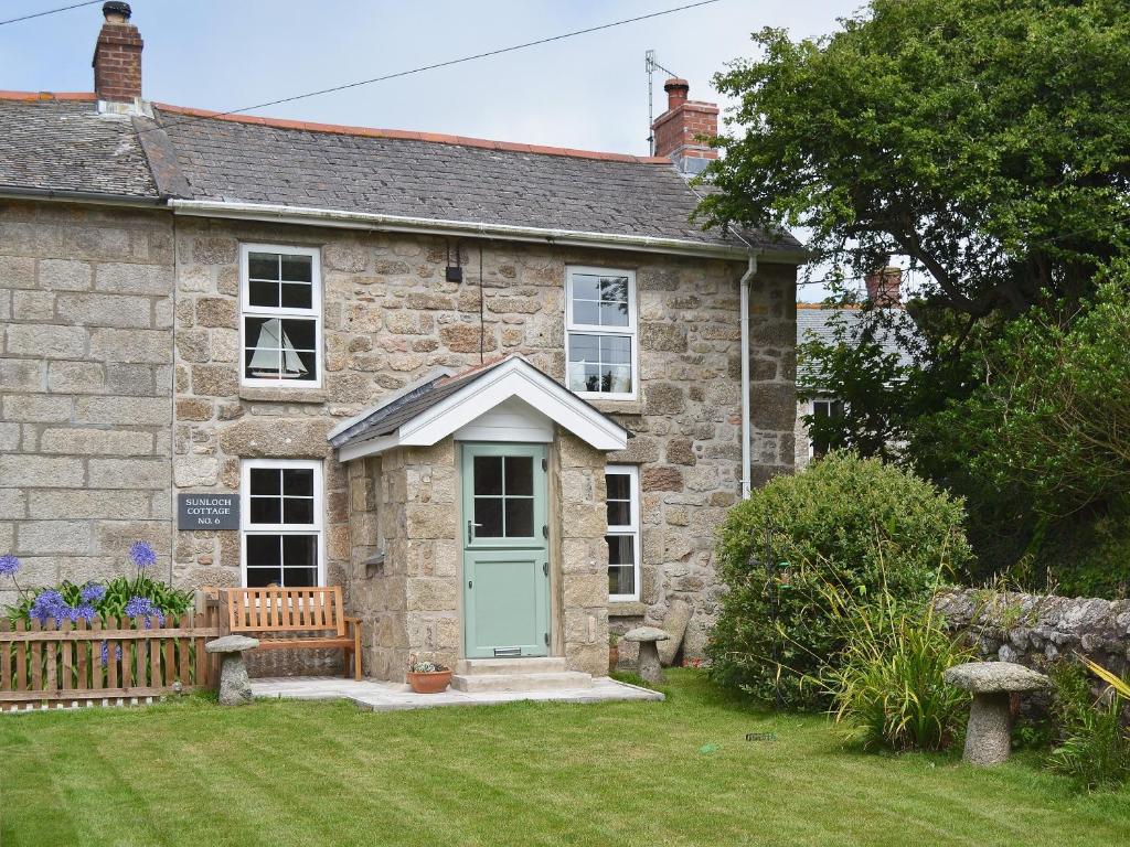 an old stone house with a blue door at Sunloch Cottage in St Just