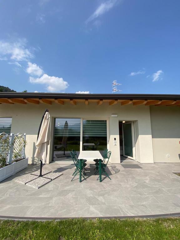 a patio with a table and chairs and an umbrella at Chalet Marghe 2 in Rovetta