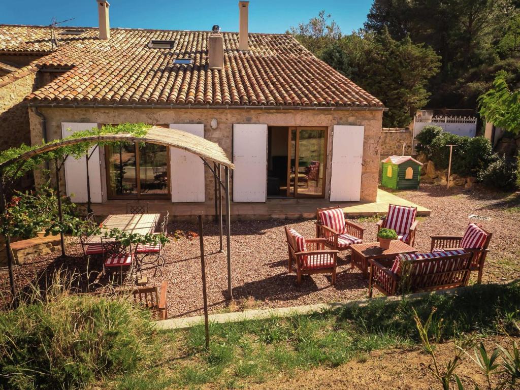 a group of chairs and a table in a yard at Sunny Escape to Serenity in Fraissé-des-Corbières