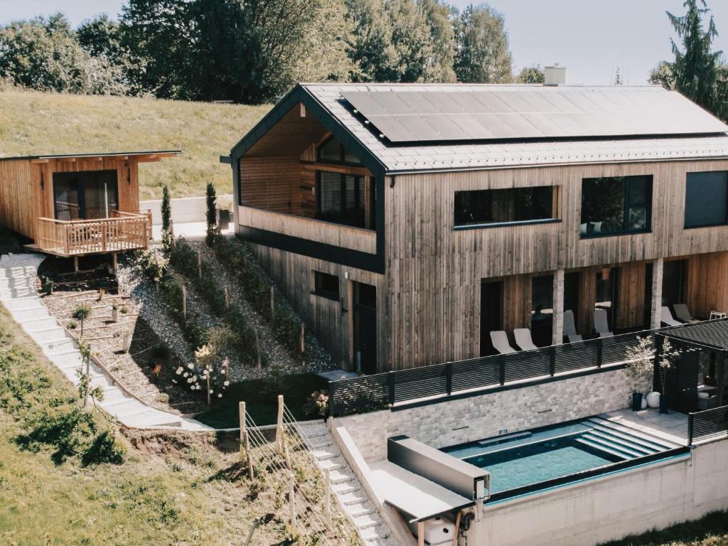 a home with a swimming pool and a house at Holiday Home Haus am Kogl by Interhome in Wies