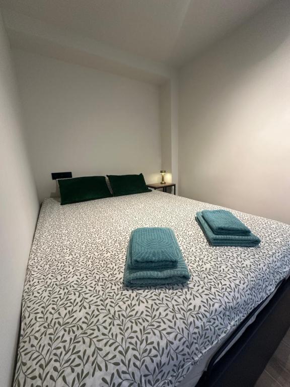 a bedroom with a bed with two towels on it at Mamba Garden III in Calpe