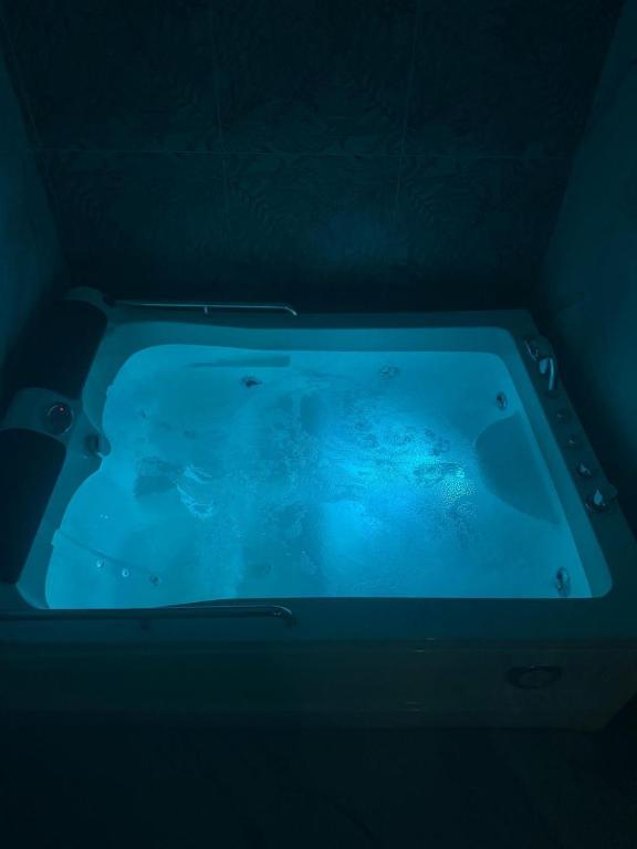 a blue bath tub in a dark room at Dolce Relax in Catania
