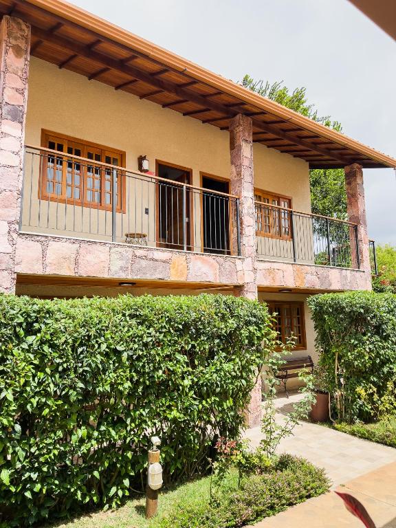 a house with a balcony on the side of it at Vila Diamantina in Mucugê