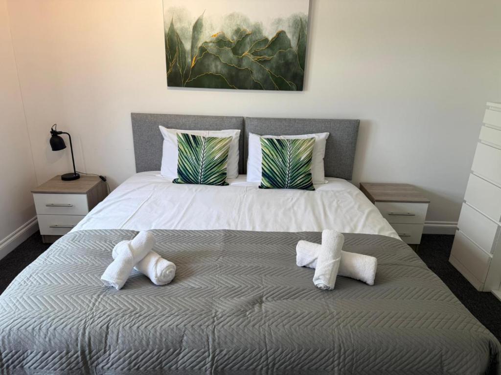 a bedroom with a large bed with towels on it at Victoria House in Littleport