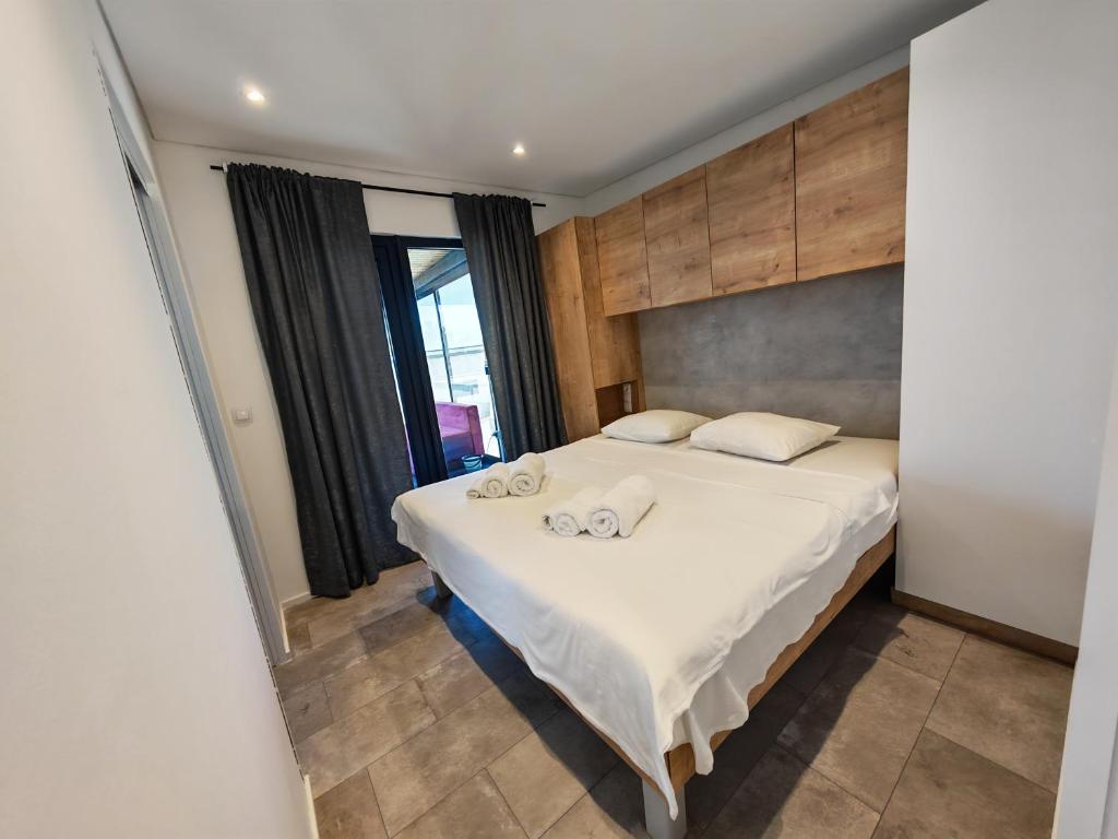 a bedroom with a bed with two towels on it at Sea view Anika by Vellaris, Luxury Mobile Home in Mali Lošinj