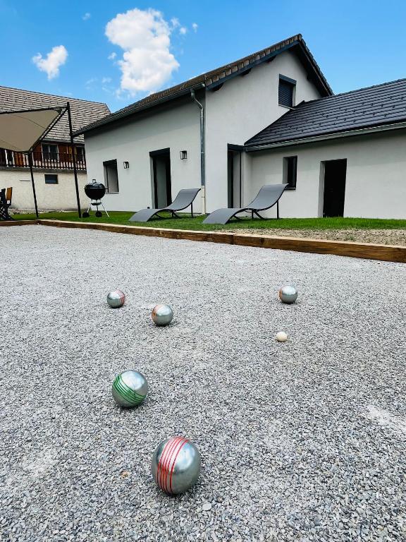 a group of balls on the ground in front of a building at L'écrin du Ferrand in Le Dévoluy