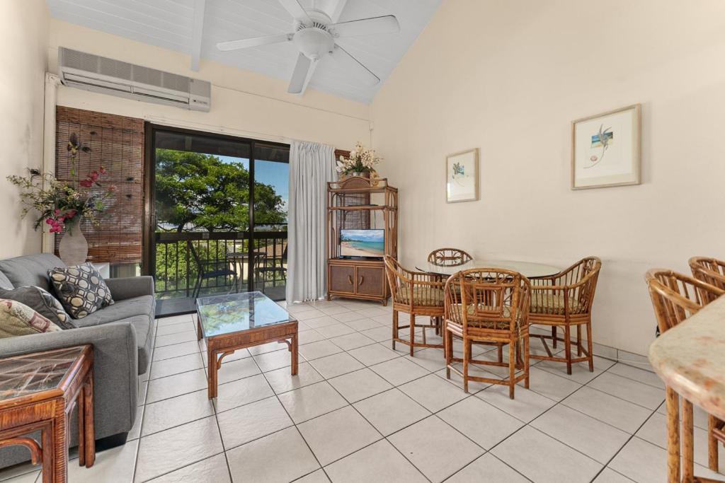 a living room with a couch and a table and chairs at Maui Vista 2422 in Kihei