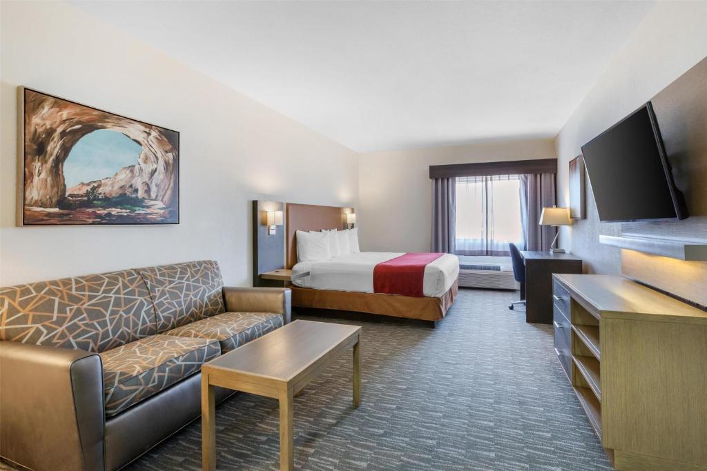 a hotel room with a bed and a couch at Best Western Inn of Payson in Payson