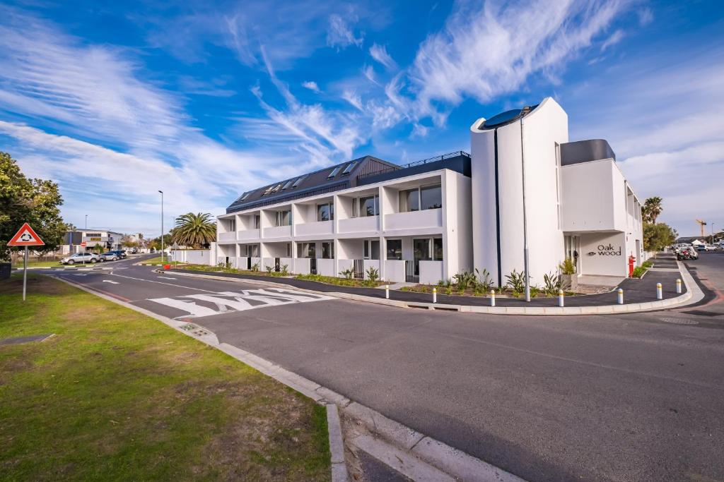 a large white building on the side of a road at Chic Coastal Hideaway in Hermanus
