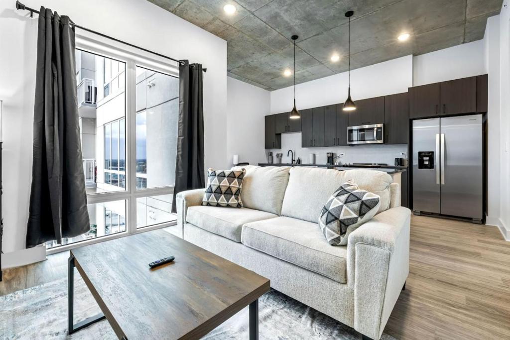 a living room with a couch and a table at Modern Channelside 1BD Apartment | Close to DT! in Tampa
