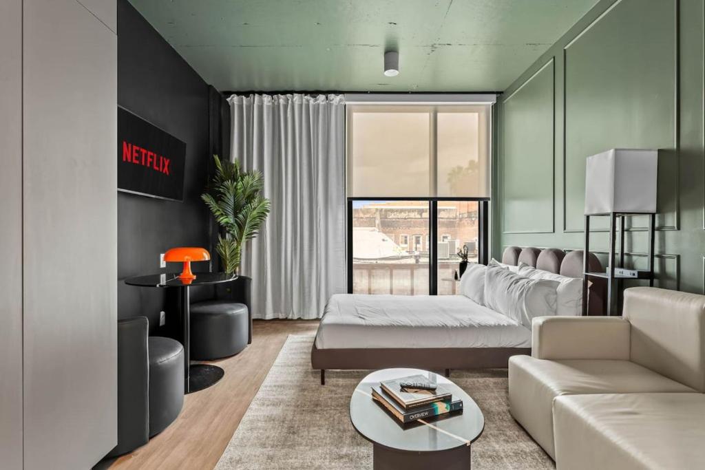 a living room with a couch and a table at Trendy Ybor Studio Free Parking Close to DT in Tampa