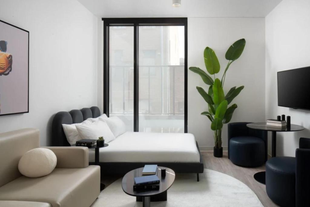 a living room with a couch and a table at Downtown Ybor Studio Escape Free Pool in Tampa