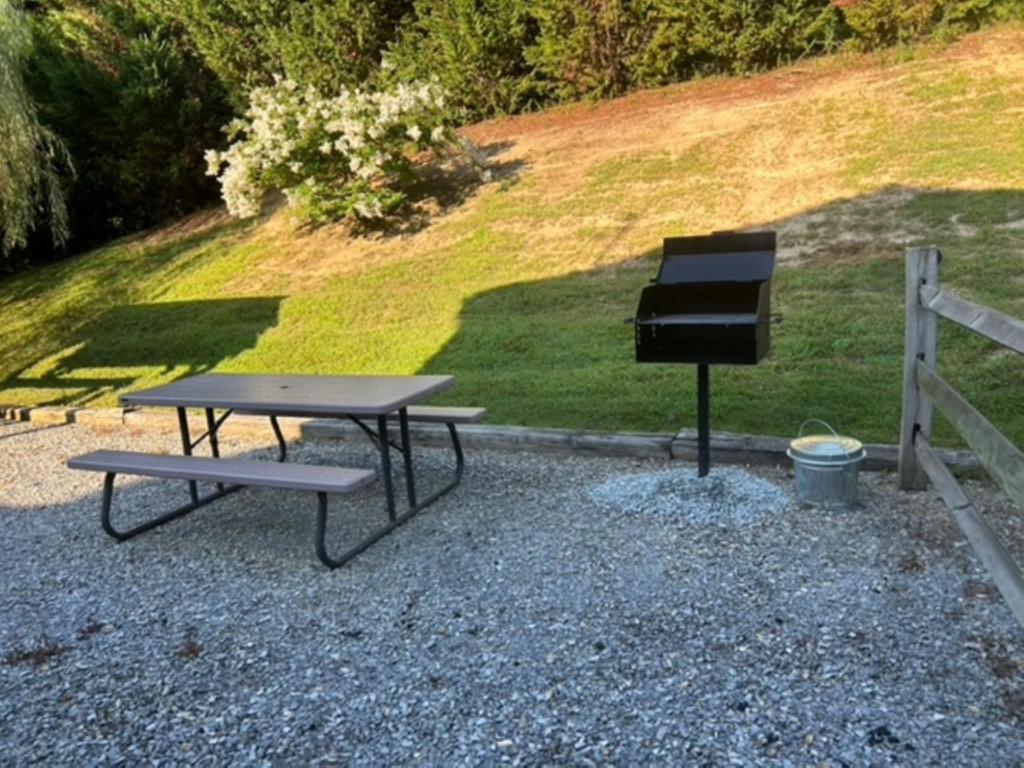 a picnic table with a grill and a piano at Heaven Sent by American Patriot Getaways in Henderson Springs