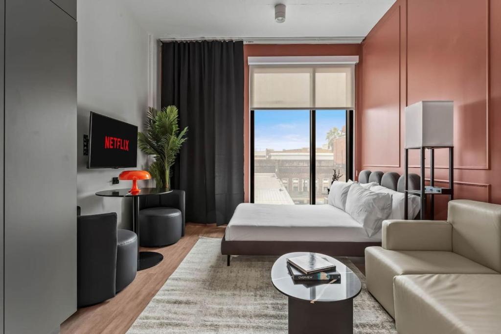 a living room with a couch and a table at Cozy Downtown Studio Free Pool Close to DT in Tampa