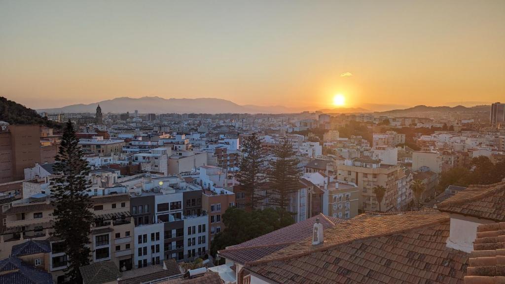 a view of a city at sunset at Casa Monte Victoria in Málaga