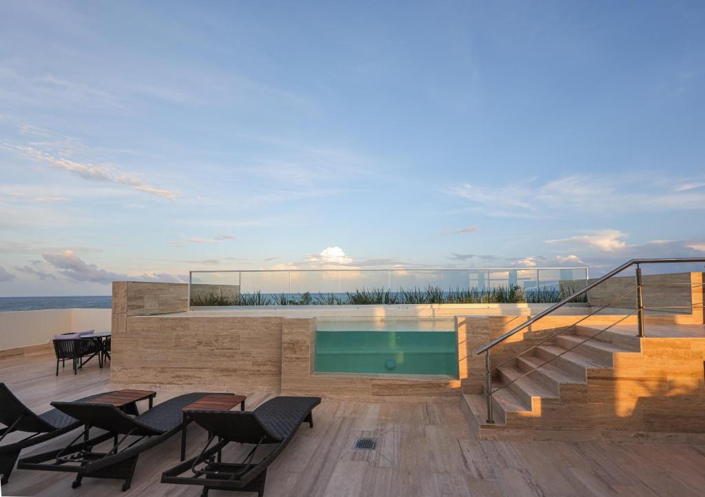 a swimming pool on the deck of a house at Distrito Puerto, Ocean & Mangrove Views in Puerto Morelos
