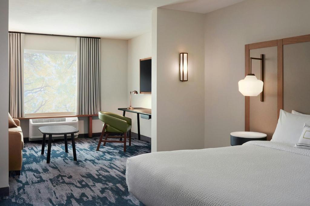 a hotel room with a bed and a desk at Fairfield by Marriott Inn & Suites Forrest City in Forrest City