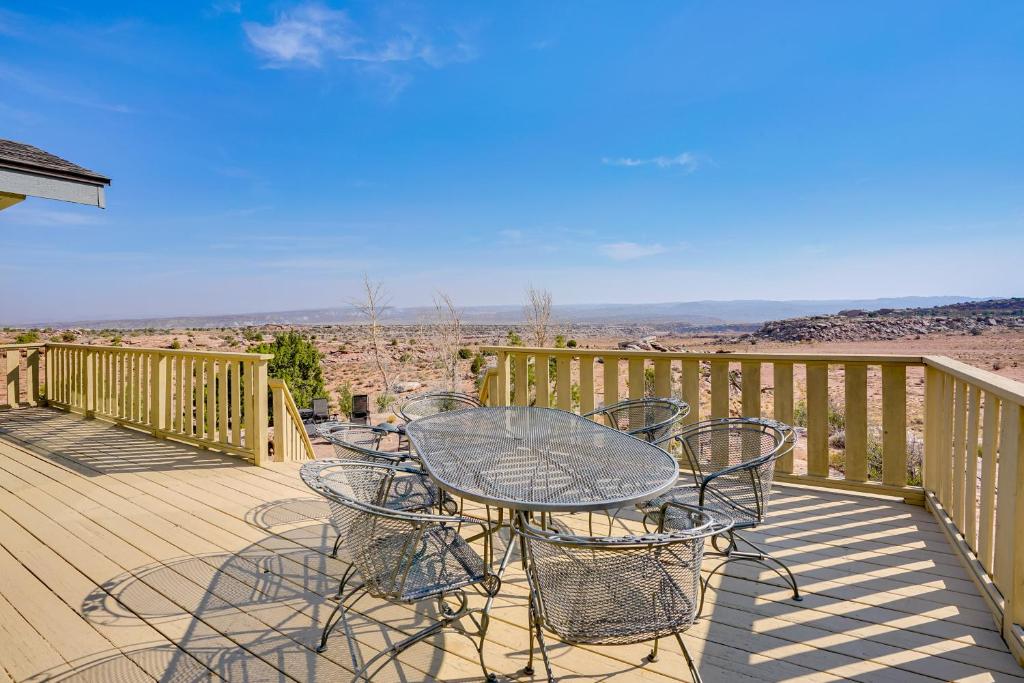 a patio with a table and chairs on a deck at Moab House Near Arches Natl Park and Canyonlands! in Moab