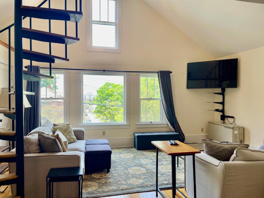 a living room with a loft bed and a couch at The Lookout - Spacious Apartment in Superb Location in Burlington