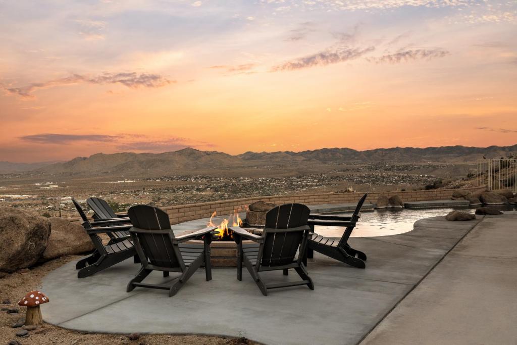 a table and chairs with a view of a city at Good Luck Outpost By The Cohost Company in Yucca Valley