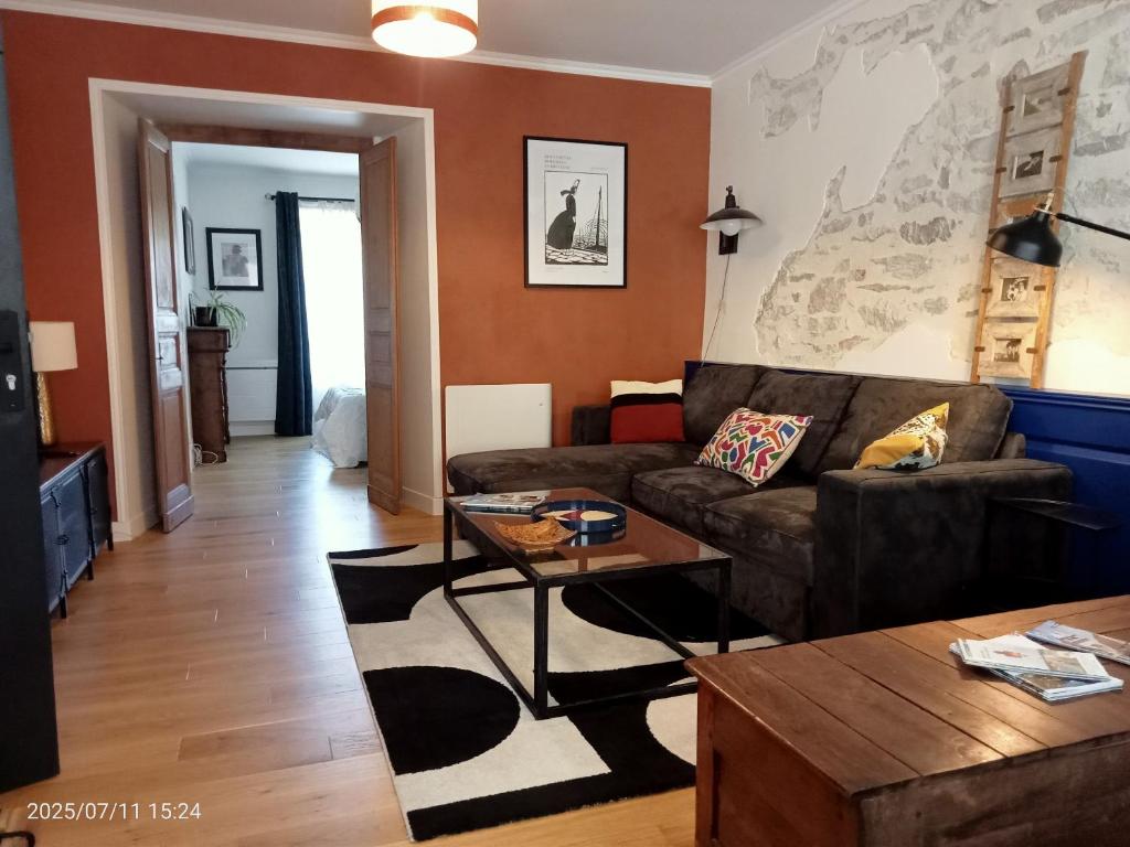 a living room with a couch and a table at Les Appartements du 31 - Centre Ville - 2è étage - 50 m2 in Quimper