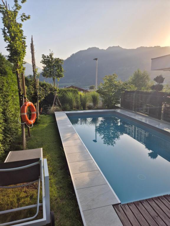 a swimming pool in the yard of a house at Freiraum 9 Living Apartment in Sankt Johann im Pongau