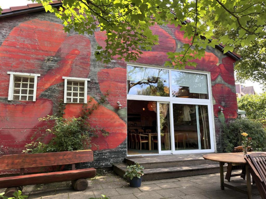 a red building with a bench in front of it at Gruppenhaus in Buntenbock in Buntenbock