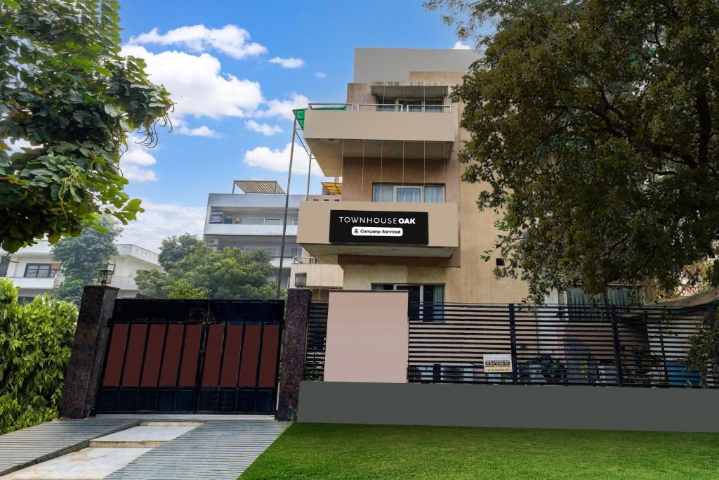 a building with a gate in front of it at Super Townhouse Oak Sector 25 Gurgaon in Gurgaon