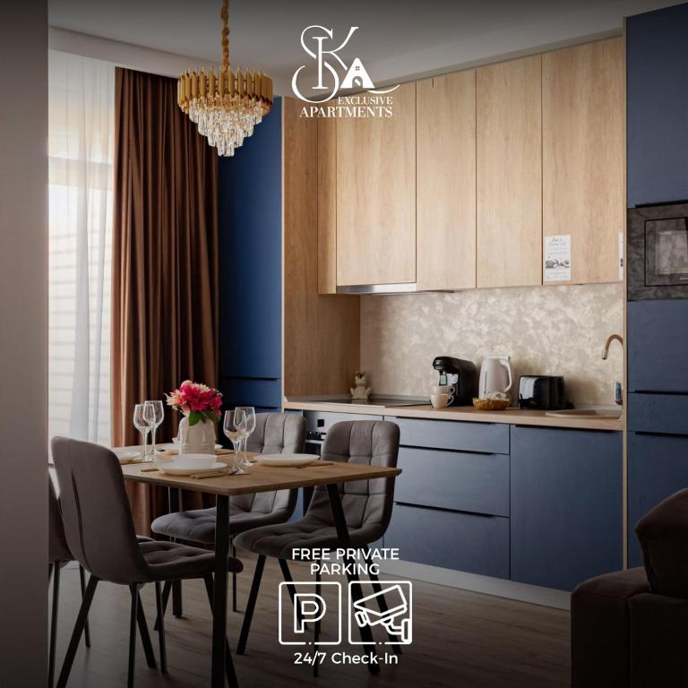 a kitchen with a table and chairs in a room at Sika Regal Apartment Arad - private garden & parking - self check-in in Arad