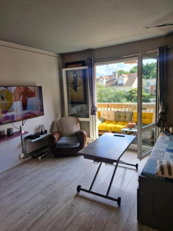 a living room with a couch and a coffee table at Cosy & Charming logement moderne proche Paris in Arcueil