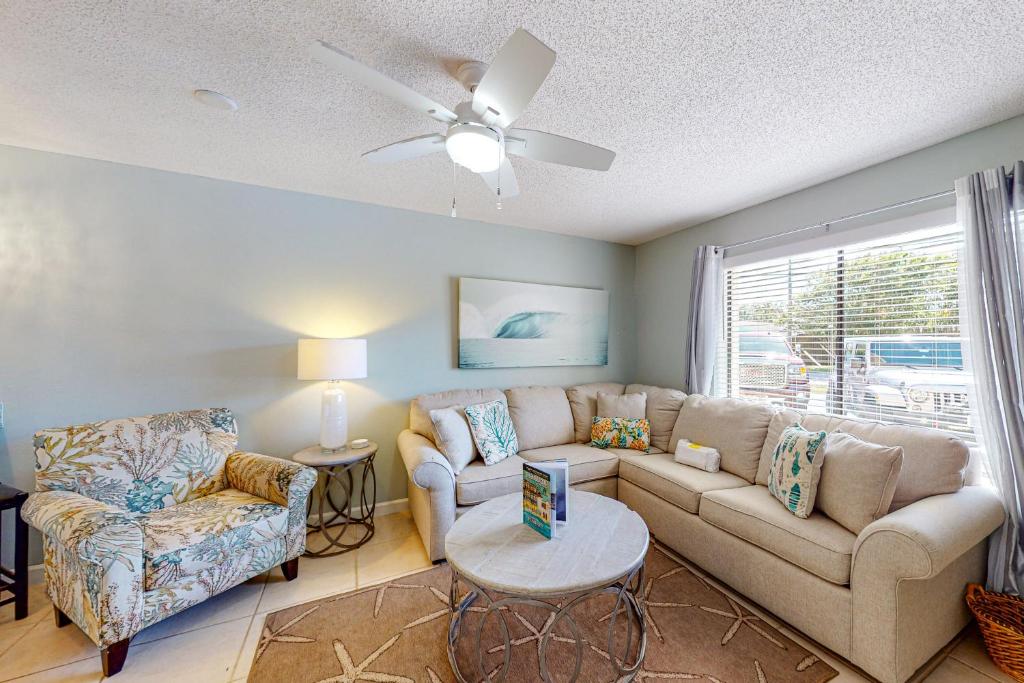 a living room with a couch and a table at Sandprints B7 in Destin