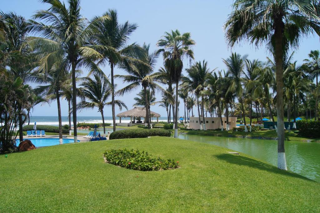 un resort con palme e una cassa d'acqua di Grand Suite Diamante Copan 301 ad Acapulco