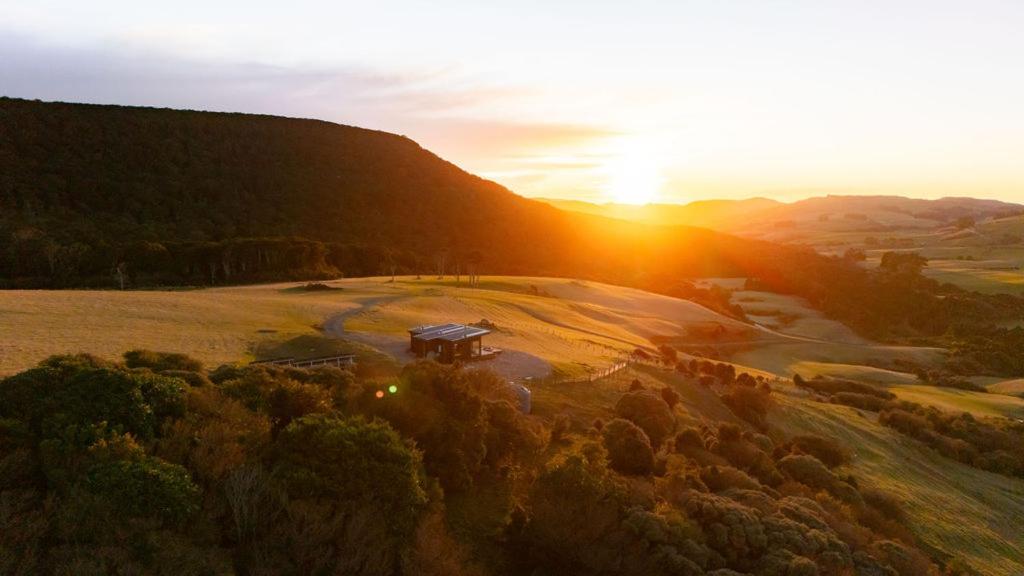 an aerial view of a field with the sun setting at Beresford Heights & Rise in Maclennan