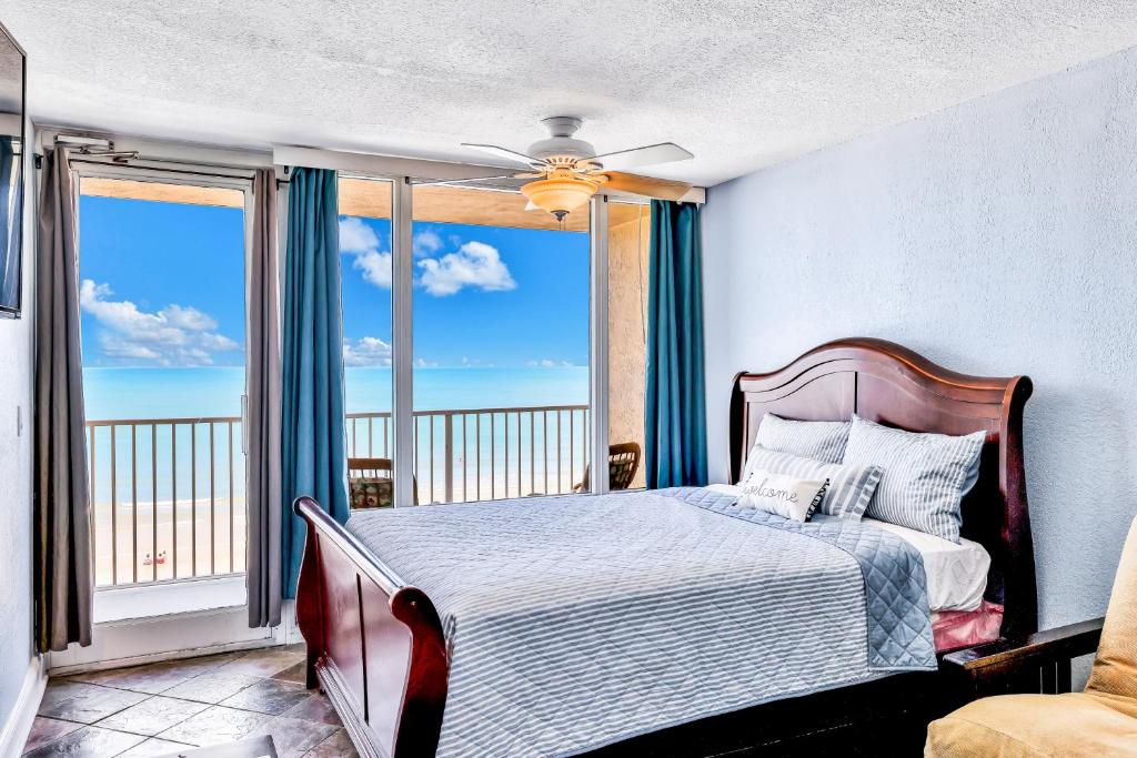 a bedroom with a bed with a view of the ocean at Atlantic Skies in Daytona Beach Shores